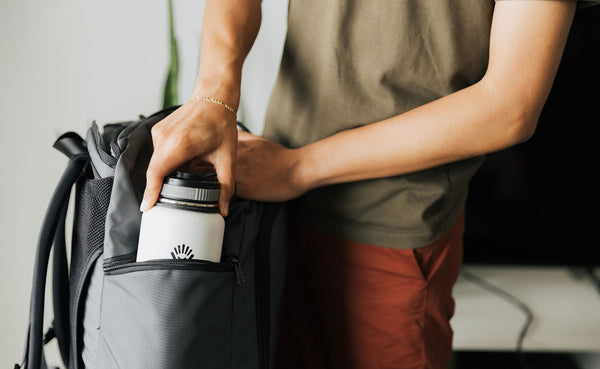 A person retrieving a bottle from the side pocket of the Techonaut 45.